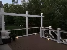 Beautiful accent lights illuminate from under the deck railing